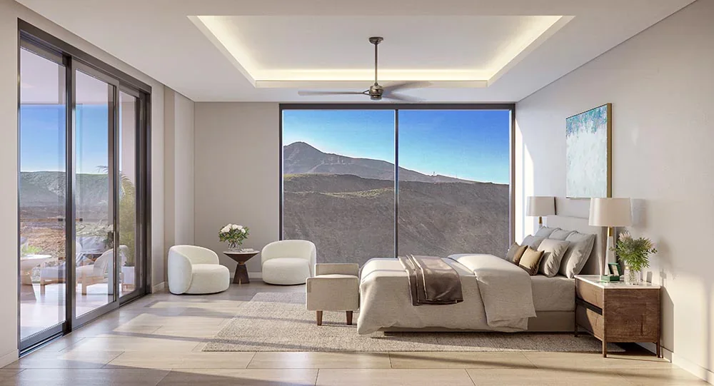 Modern bedroom with large window showing mountain view, bed with beige linens, two bedside lamps, and minimal decor.