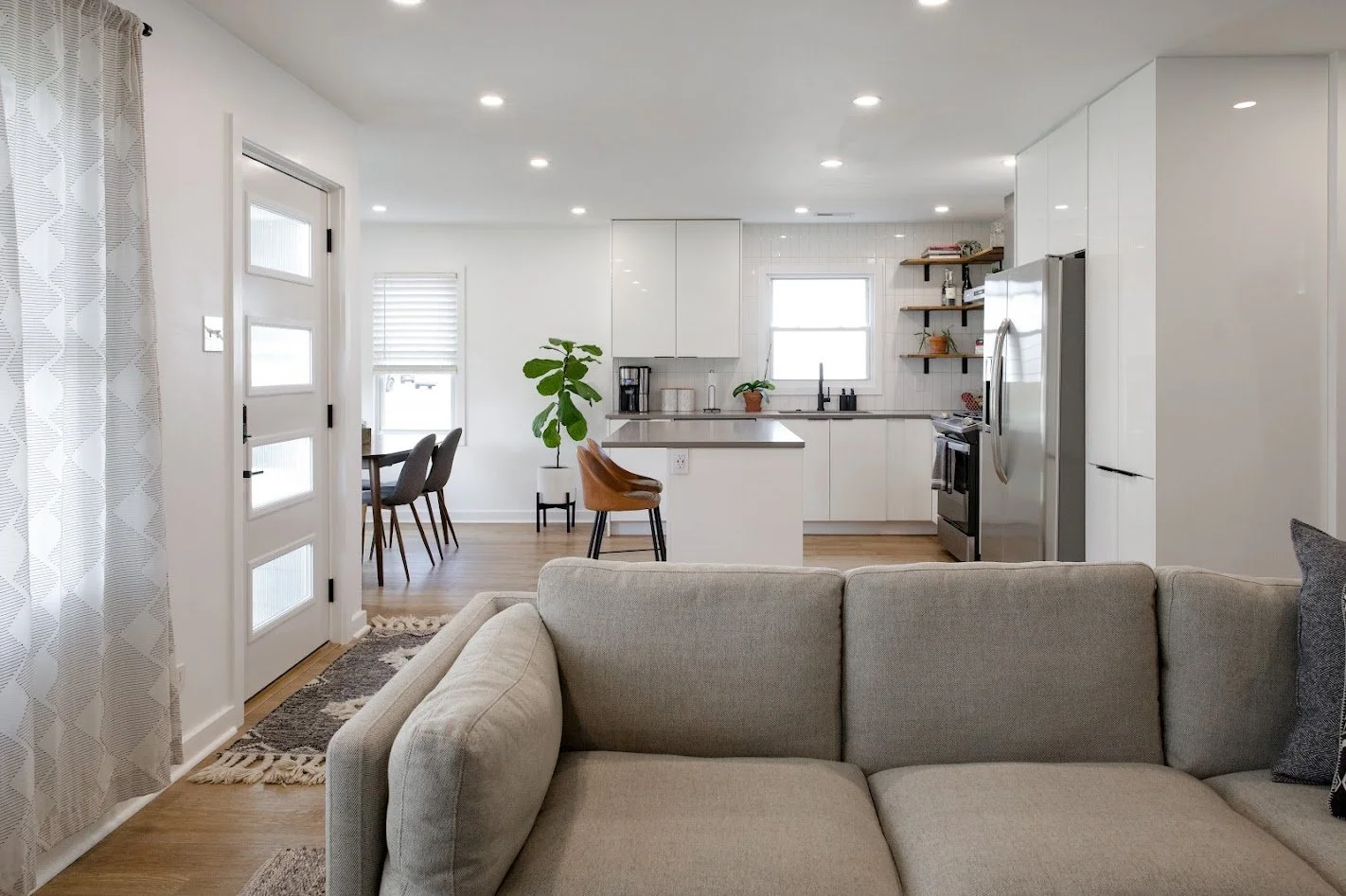Living room layout with open concept kitchen, modern finishes, quartz countertops, bright inviting interior design