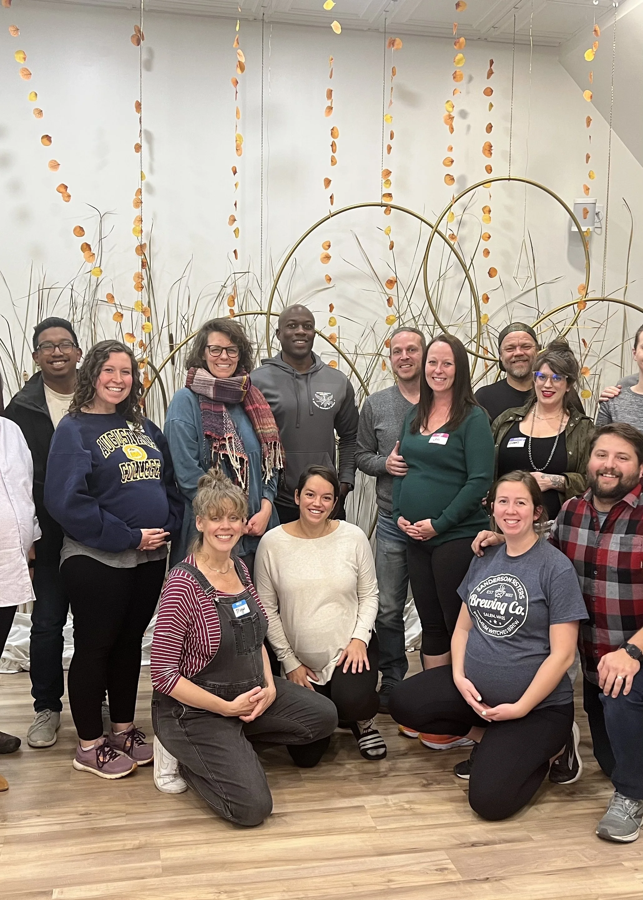 Group photo of diverse adults who have completed a Birth With Ease hypnobirthing class together.