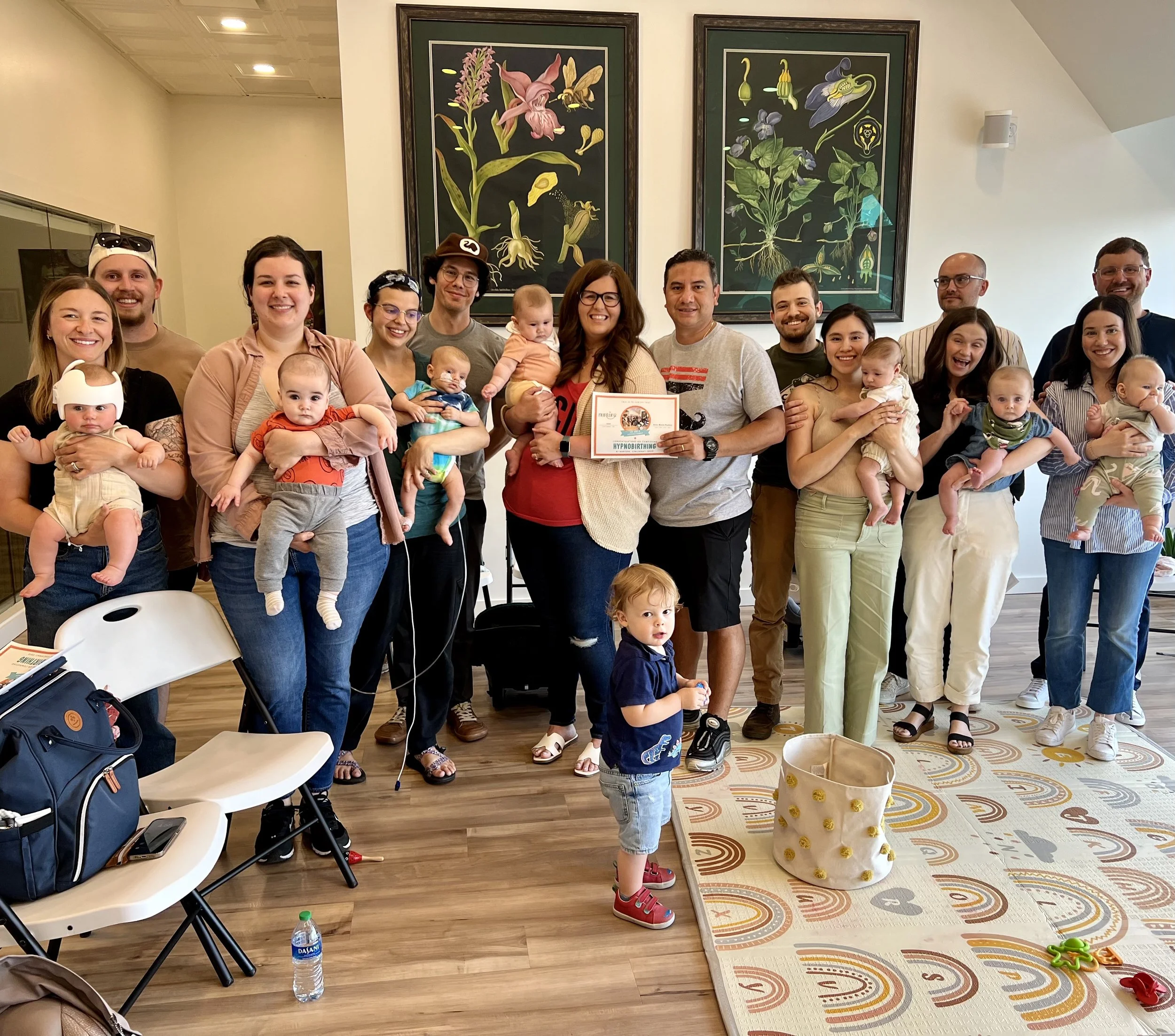 Group photo of adults and babies at a Birth With Ease hypnobirthing parenting gathering
