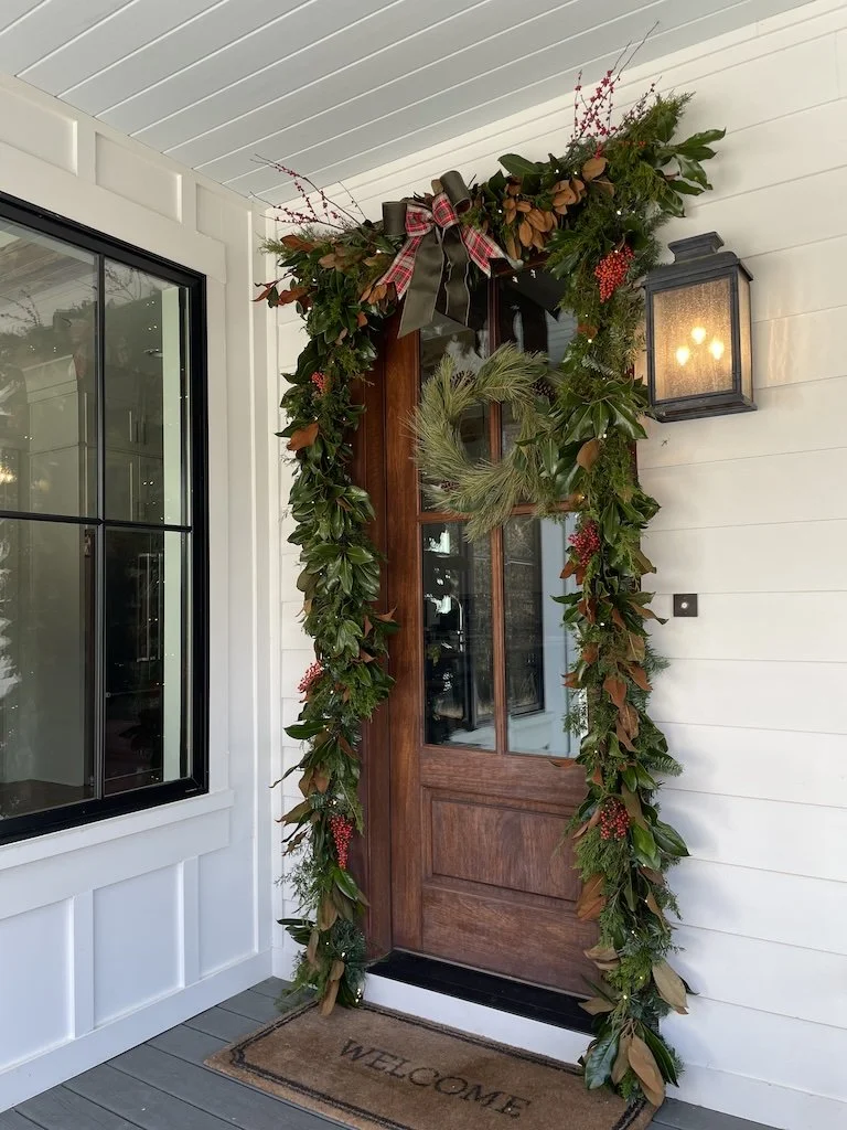 Holiday garland professionally installed over a front door