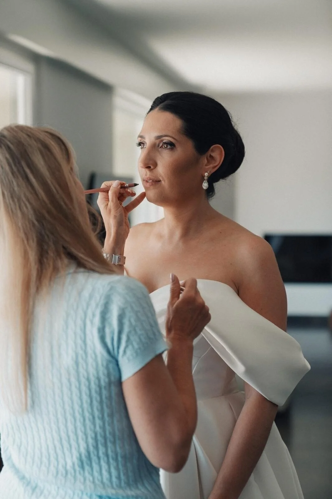 Bride_in_White_Dress_Getting_Makeup_Applied.jpg