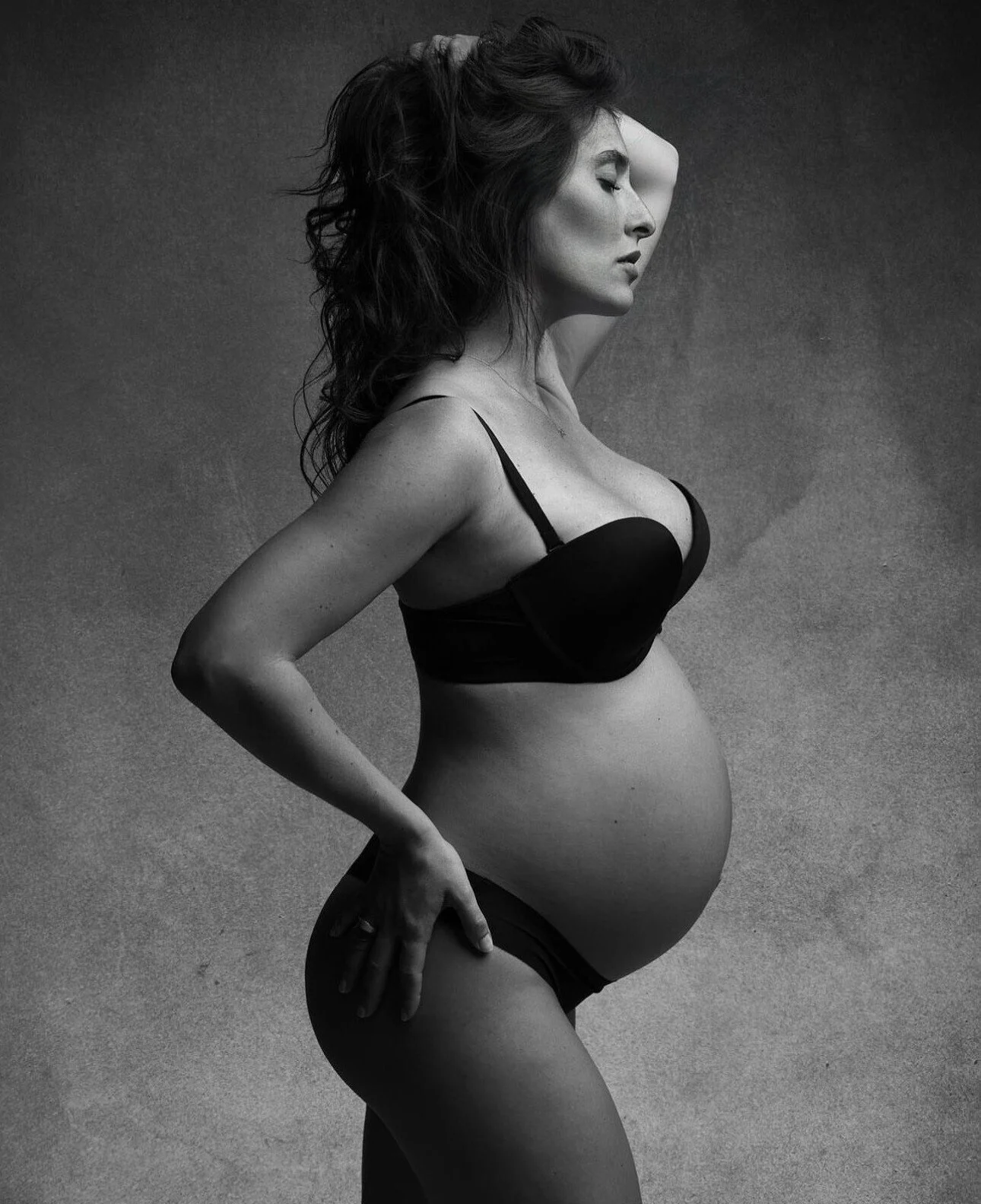 Pregnant_Woman_in_Black_Lingerie_Against_Gray_Background.jpg