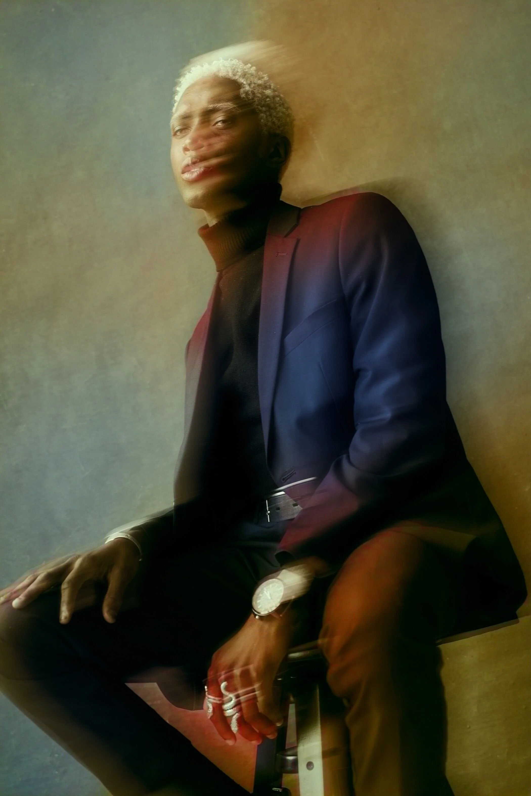 Stylish_man_in_dark_suit_with_blurred_motion_effect.jpeg