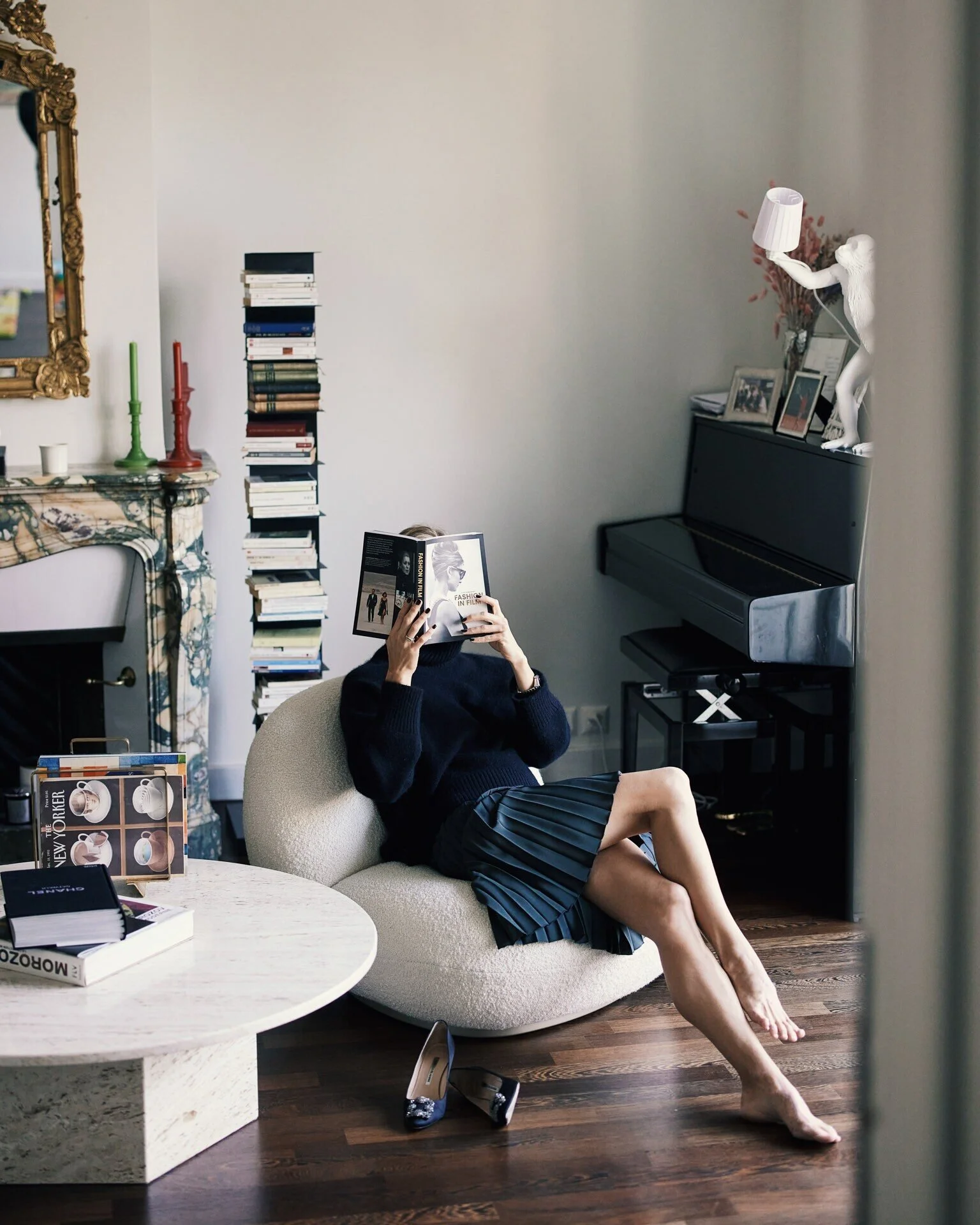 Woman_Reading_in_Cozy_Room_with_Books_and_Piano.jpeg