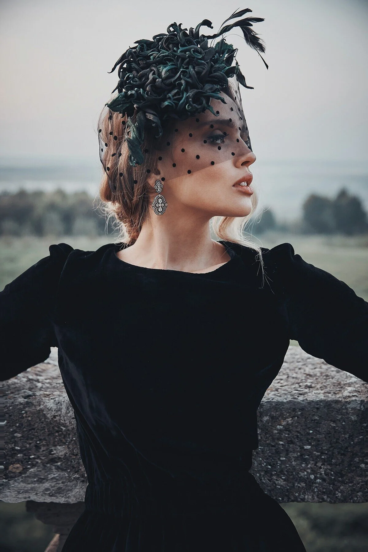 Woman_in_Black_Dress_with_Veil_and_Floral_Hat.jpg