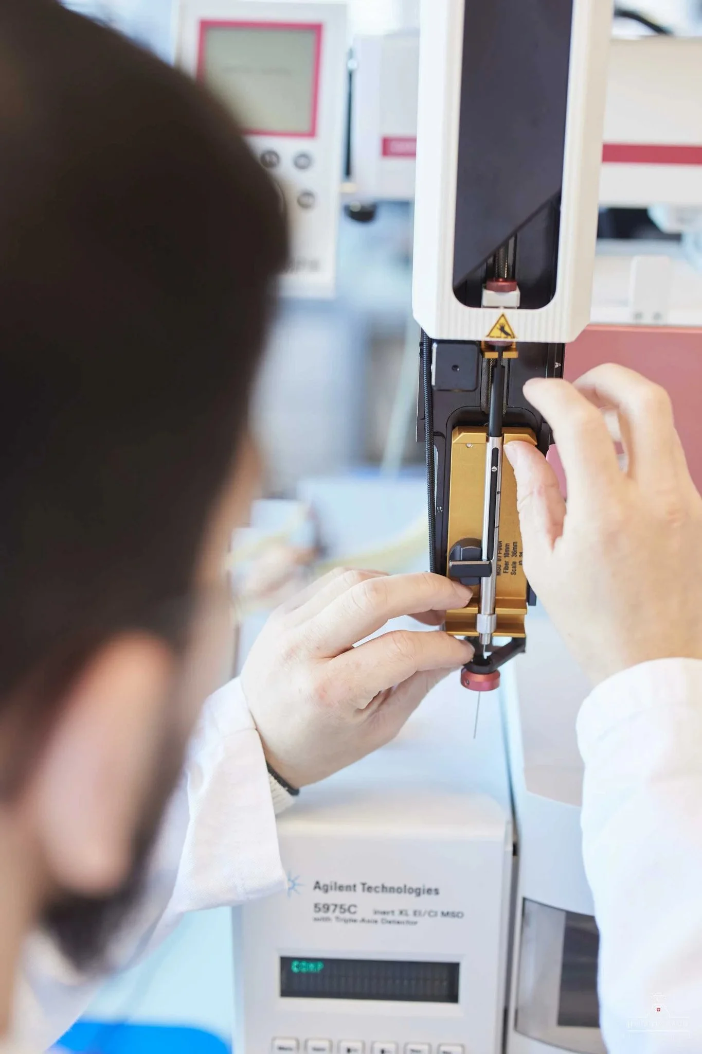 Scientist_Adjusting_Equipment_in_Laboratory_Setting.jpg