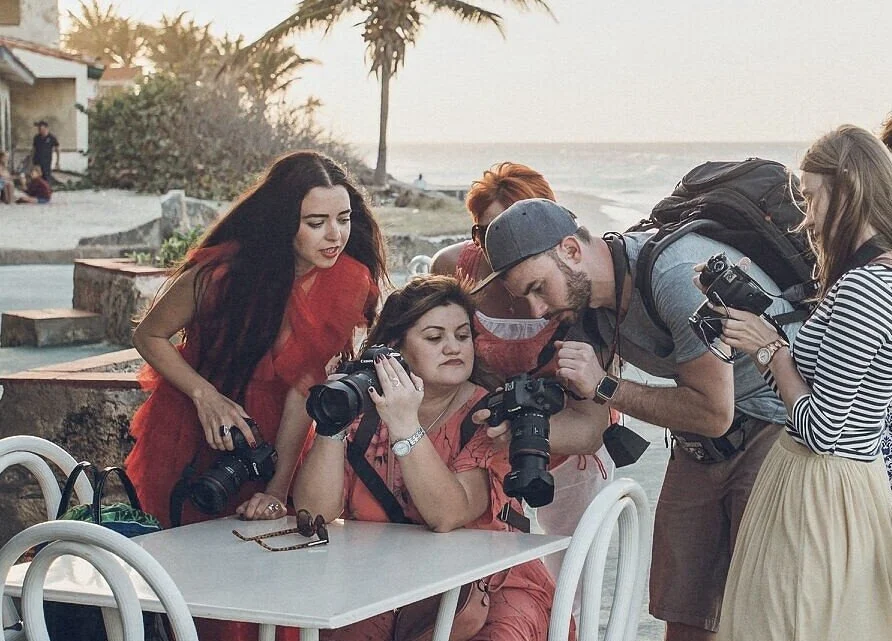 Group_of_photographers_reviewing_images_at_a_table.jpg