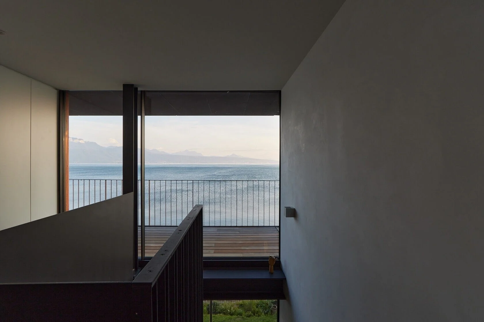 Modern_interior_with_lake_view_and_balcony.jpeg