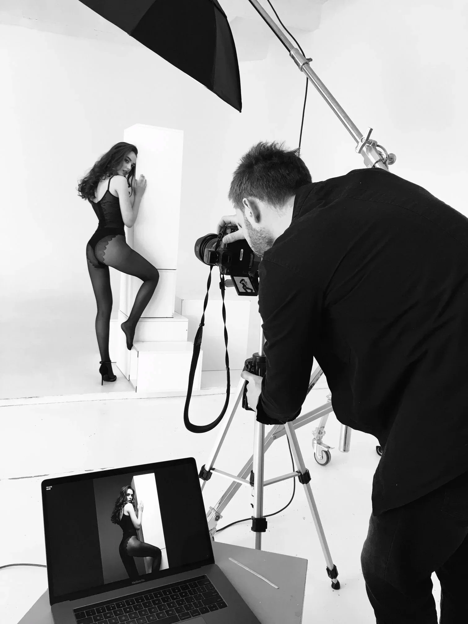 Model_in_black_lingerie_posing_by_white_backdrop.jpg