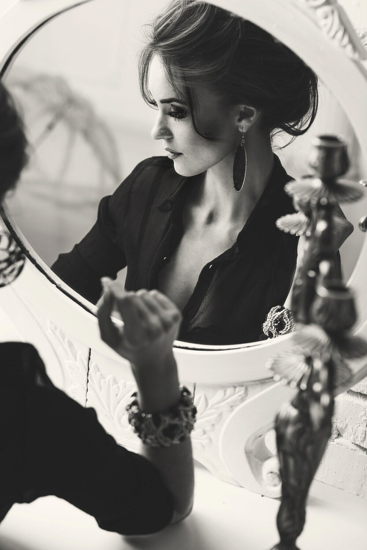 Woman_in_Black_Shirt_Reflecting_in_a_Mirror.jpg