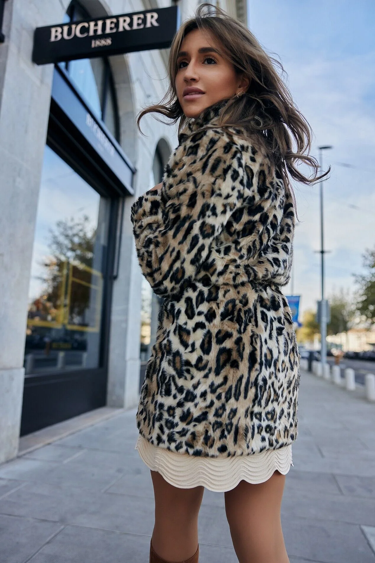 Woman_in_leopard_print_coat_on_city_street.jpg