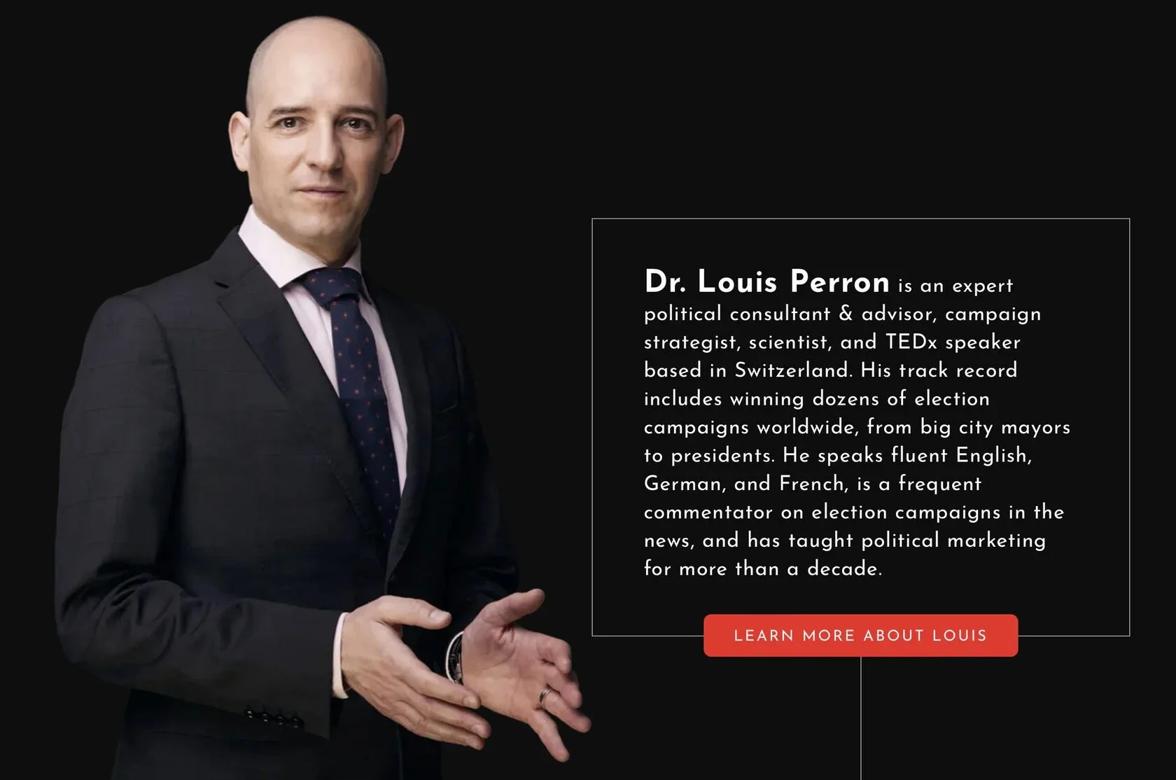 Man_in_suit_with_polka_dot_tie_against_black_background.jpg
