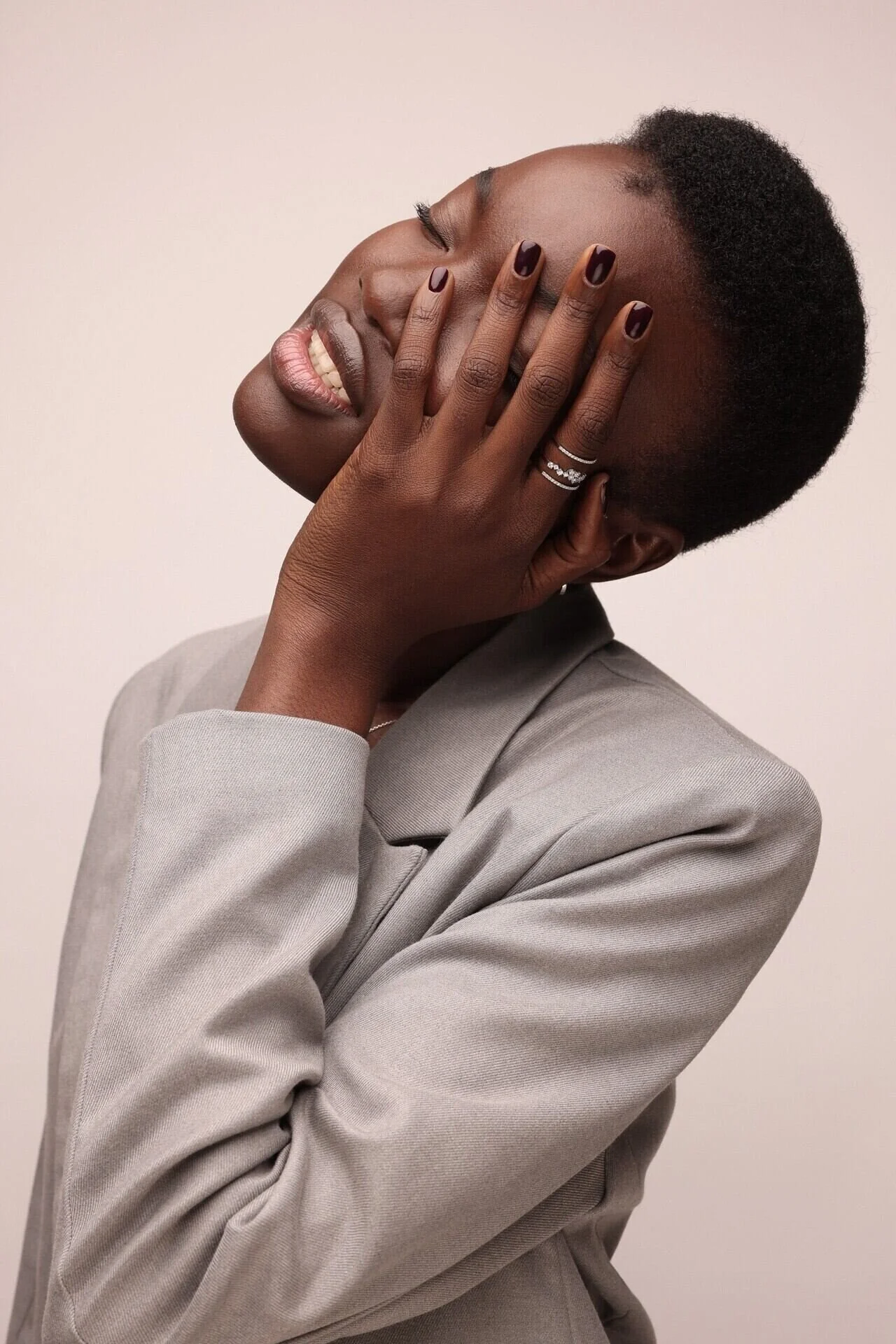 Woman_in_Grey_Blazer_with_Short_Hair_and_Hand_on_Face.jpeg