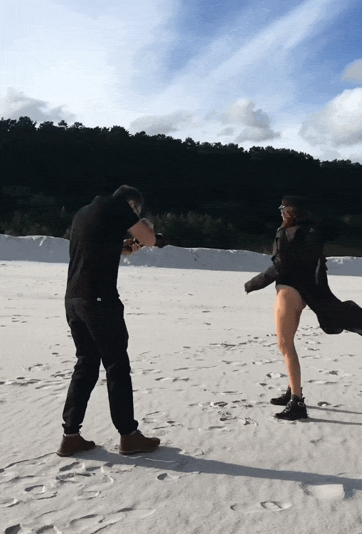 Le photographe professionnel Yaroslav Monchak dirige une séance de photos de mode sur une plage de sable.