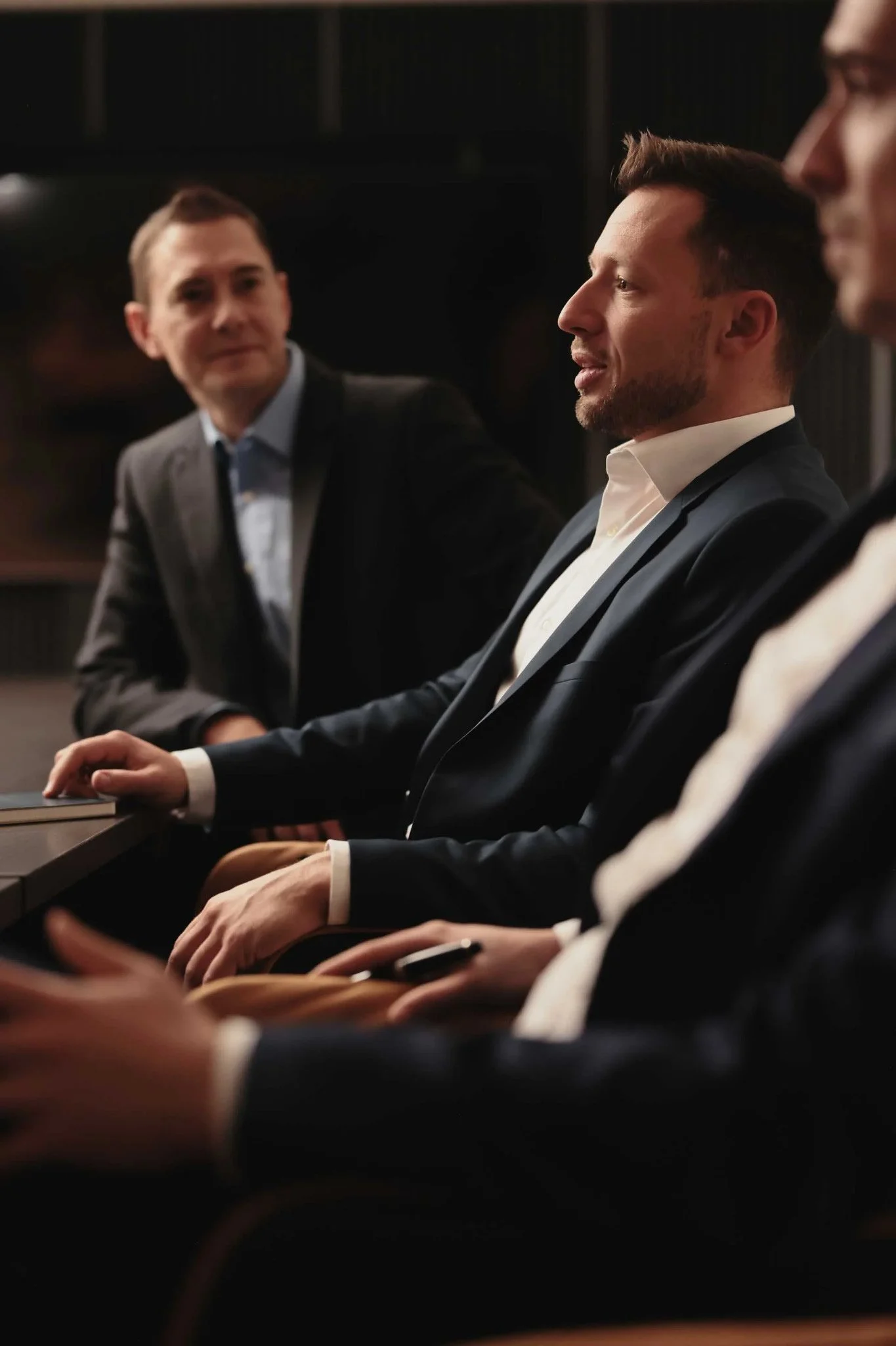 Businessmen_in_Suits_Engaged_in_Discussion.jpg