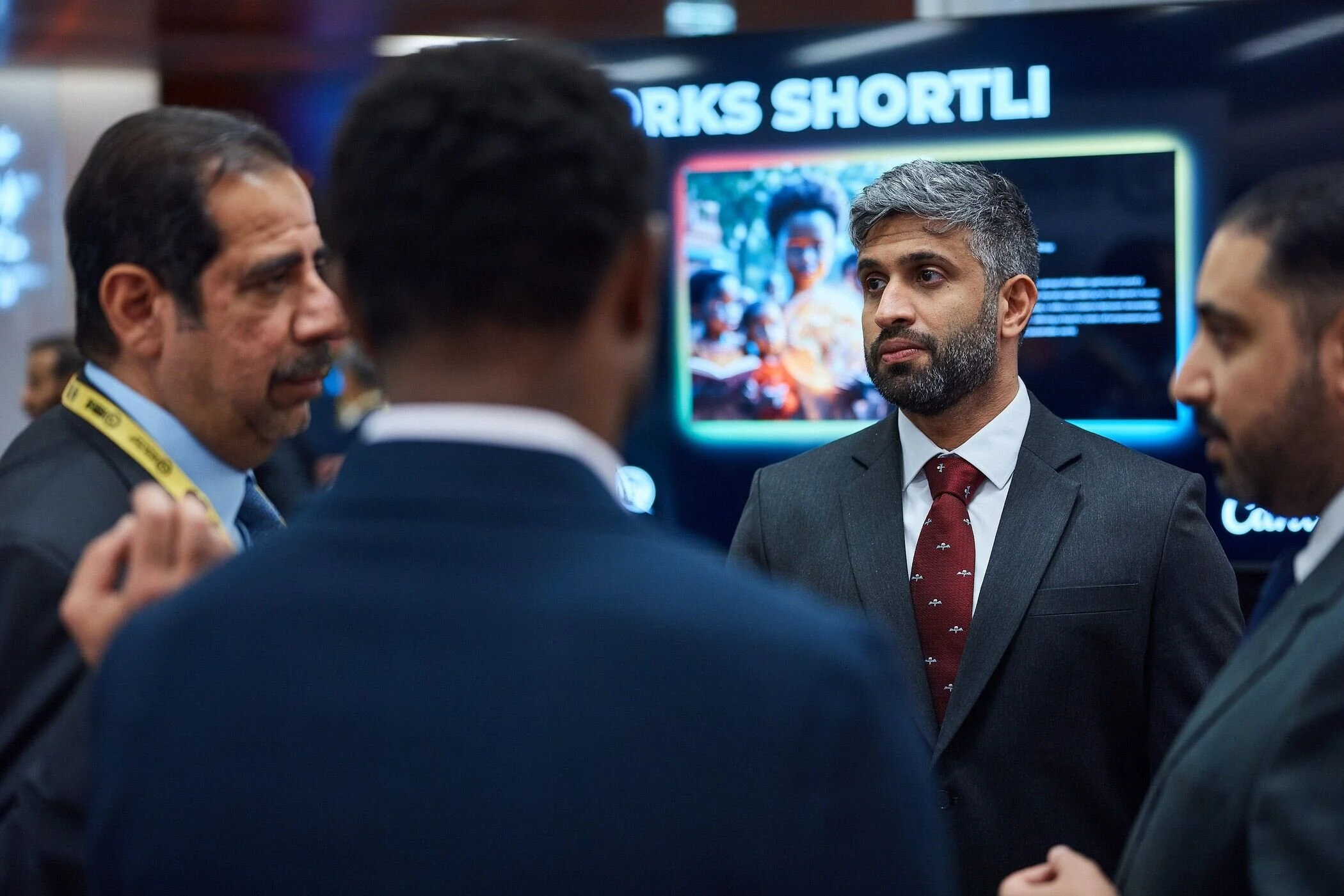 Businessmen_in_Suits_Engaged_in_Discussion_at_Event.jpg