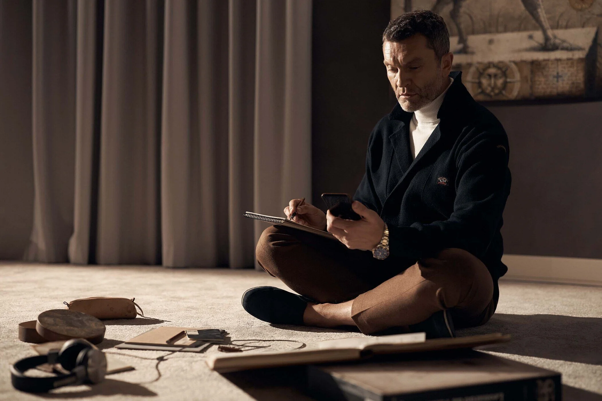 Man_Sitting_on_Floor_with_Notebook.jpg