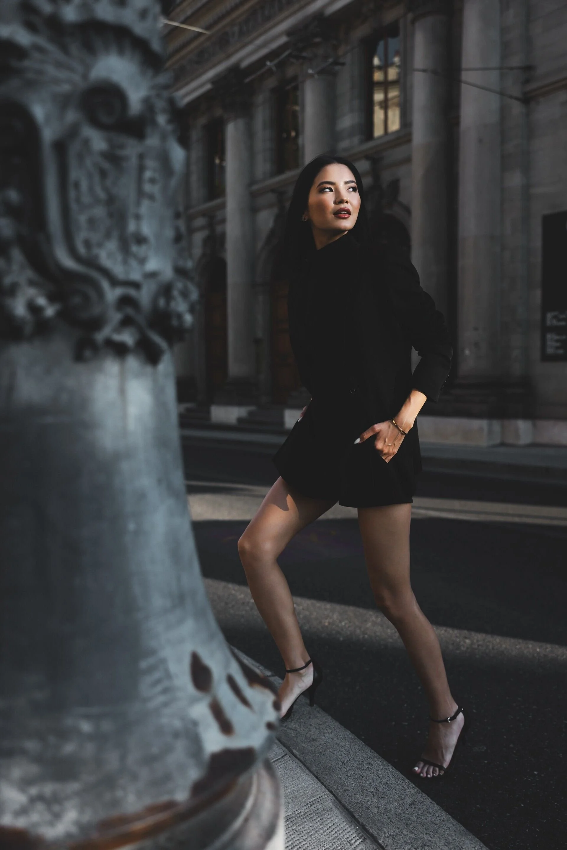 Woman_in_Black_Outfit_Posing_Near_Historic_Building.jpg