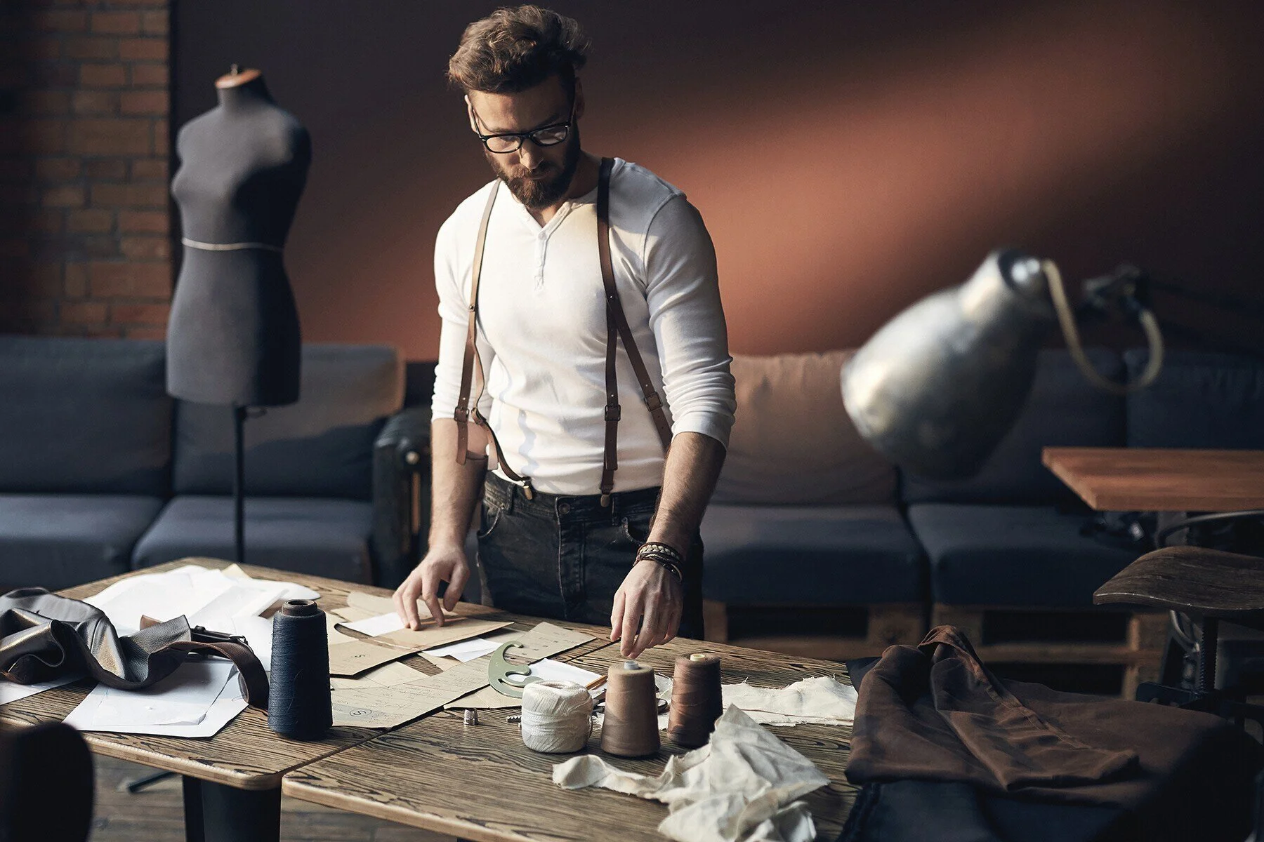 Tailor_Working_with_Fabrics_and_Patterns_in_Studio.jpg