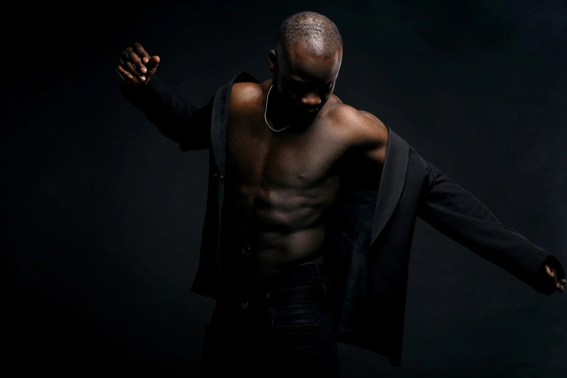 Man_in_Black_Jacket_Posing_with_Bare_Torso.jpg