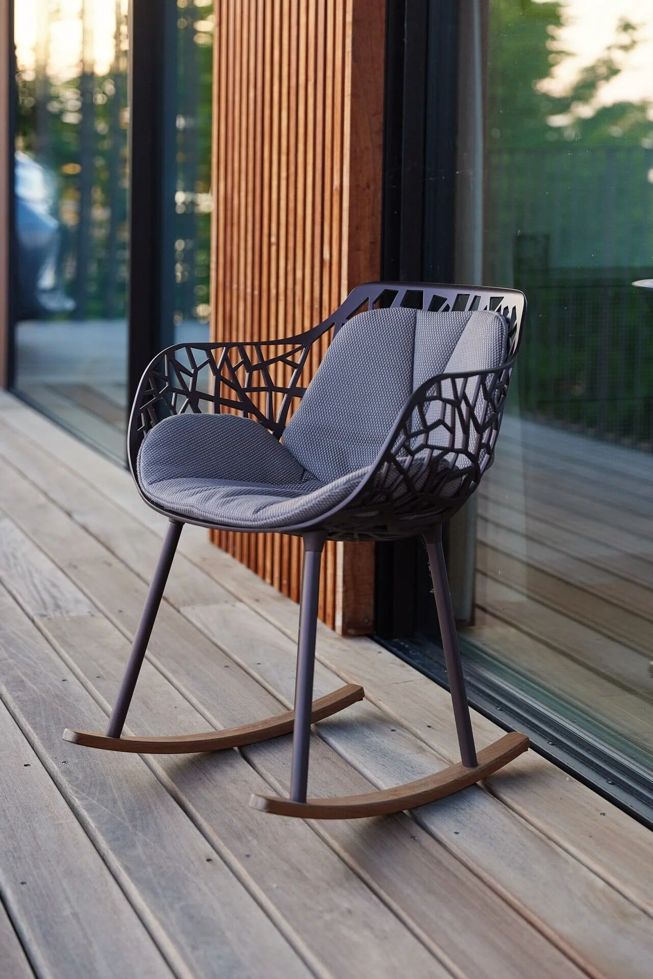 Modern_grey_rocking_chair_on_wooden_deck.jpeg