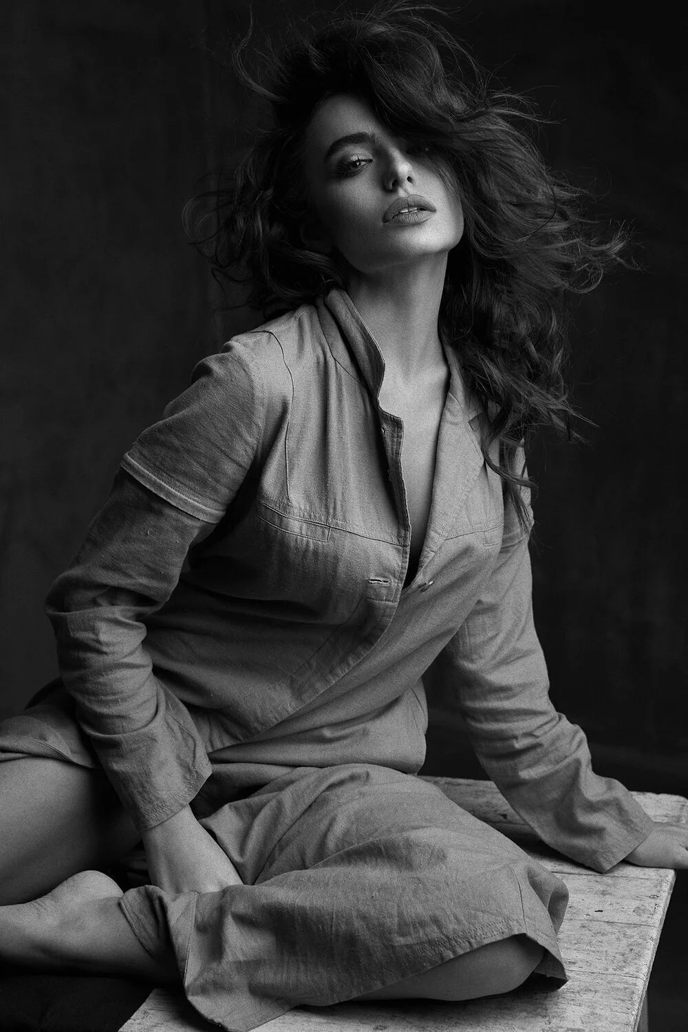 Woman_in_Grey_Outfit_with_Flowing_Hair_in_Studio_Setting.jpg