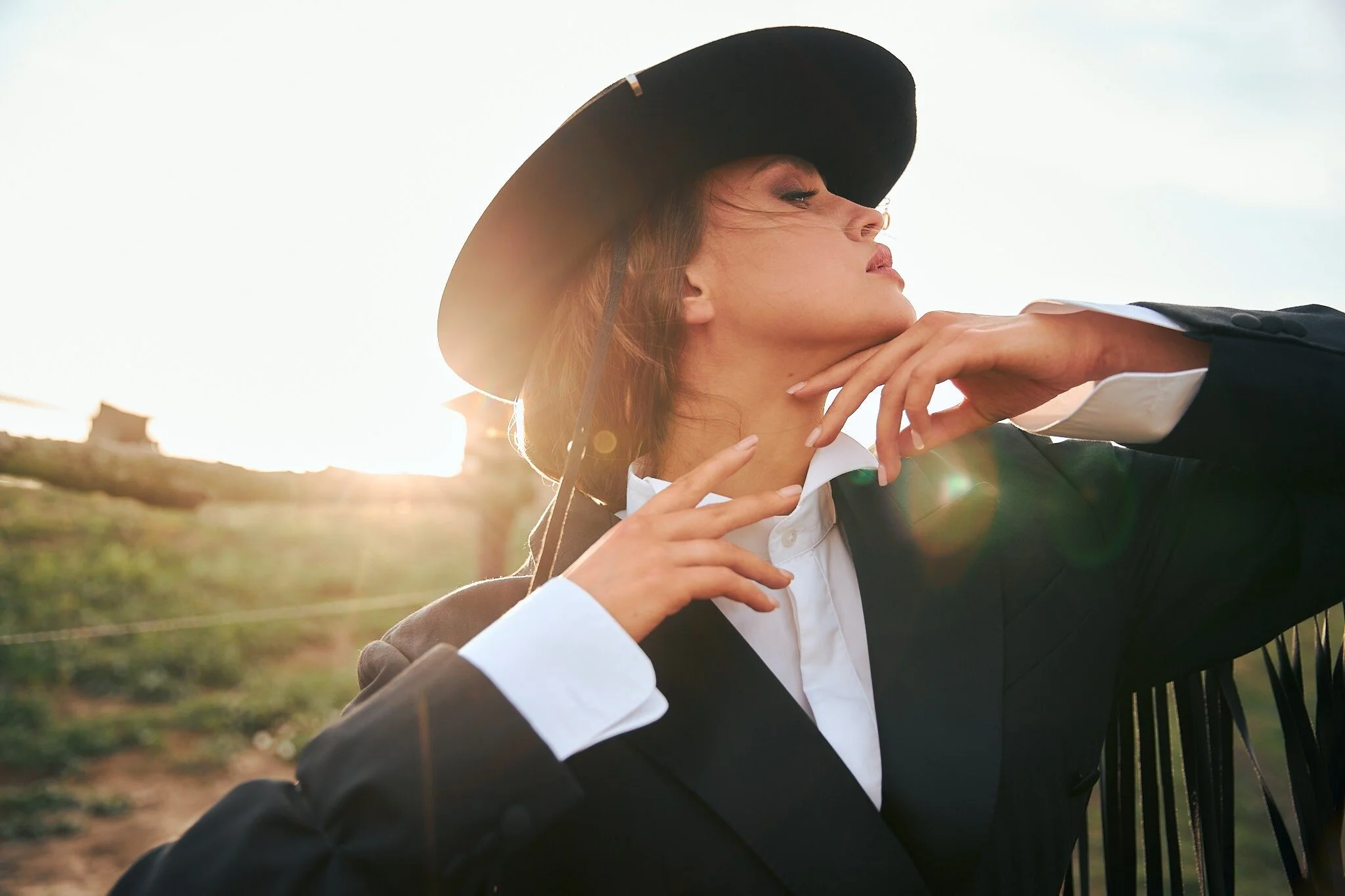 Woman_in_Black_Hat_and_Suit_Posing_at_Sunset.jpg