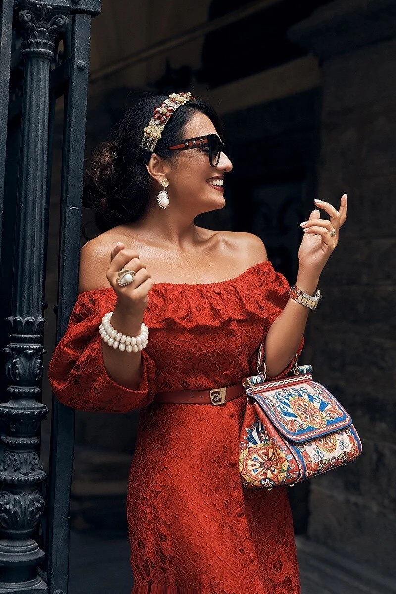 Woman_in_Red_Lace_Dress_with_Colorful_Handbag.jpg