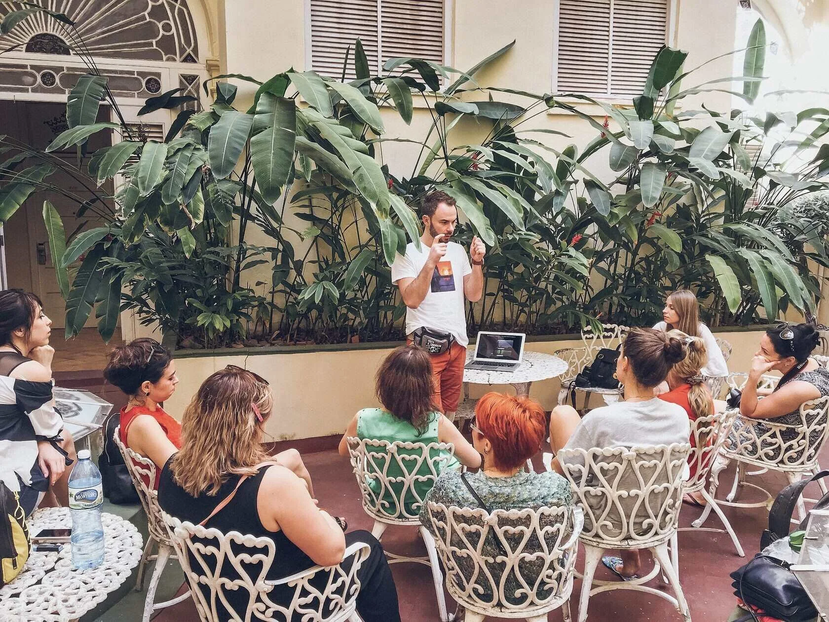 Man_presenting_to_a_group_in_a_garden_setting.jpg