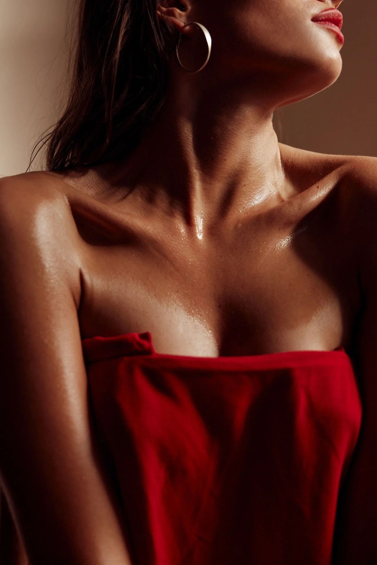 Woman_in_Red_Cloth_with_Silver_Earrings_and_Glossy_Skin.jpeg