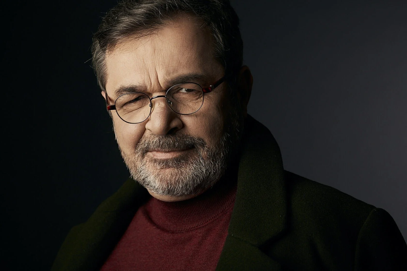 Man_in_glasses_with_beard_wearing_dark_coat_and_red_sweater.jpg