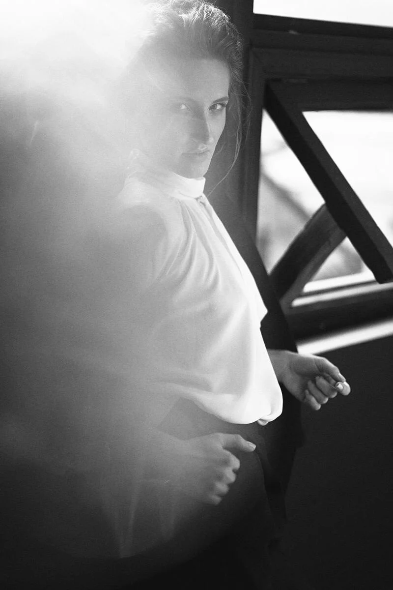 Woman_in_White_Blouse_Posing_by_Window_with_Soft_Light.jpg