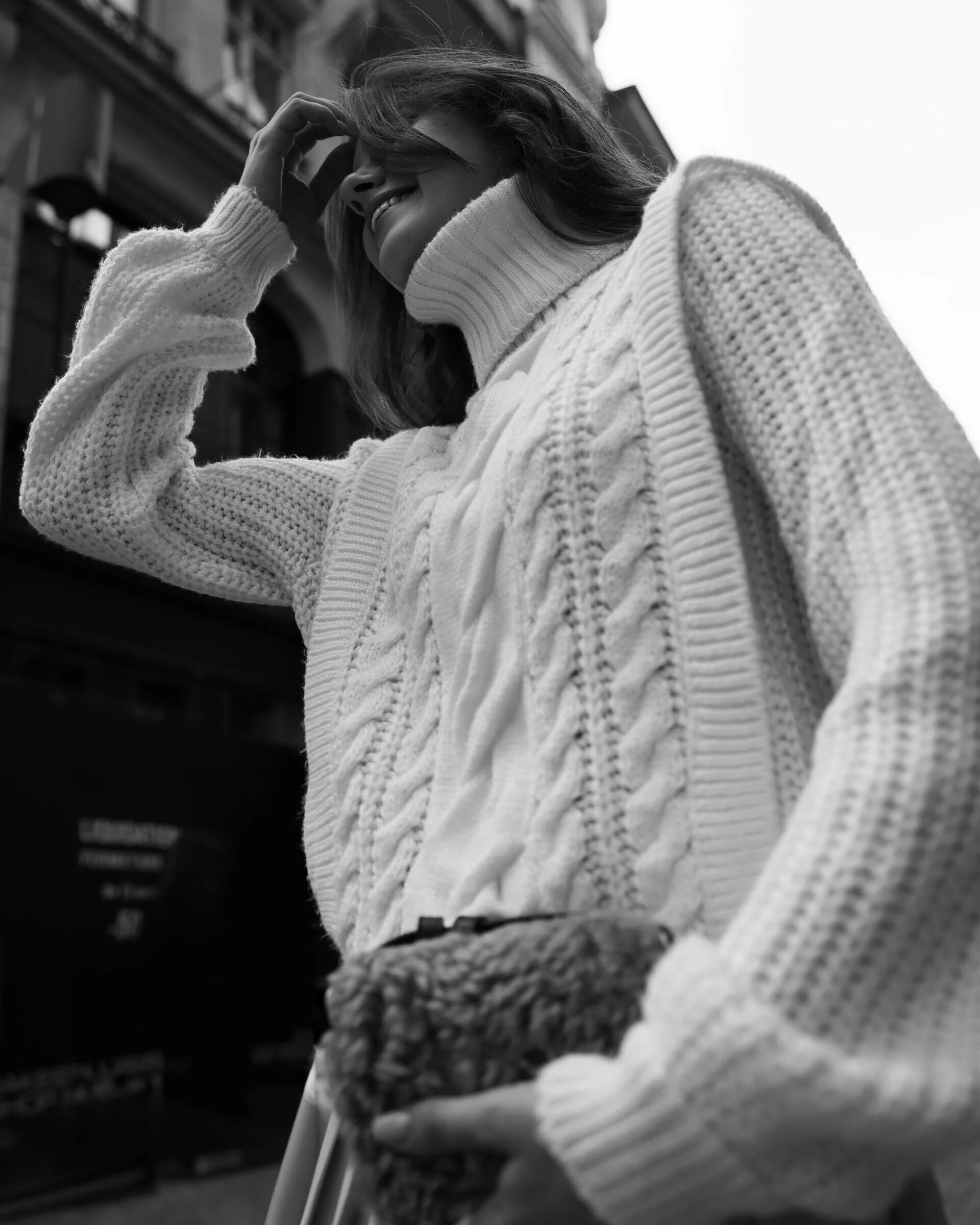 Woman_in_White_Sweater_Smiling_Outdoors.jpg