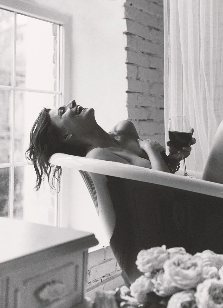 Woman_Laughing_in_Bathtub_with_Wine_Glass.jpg