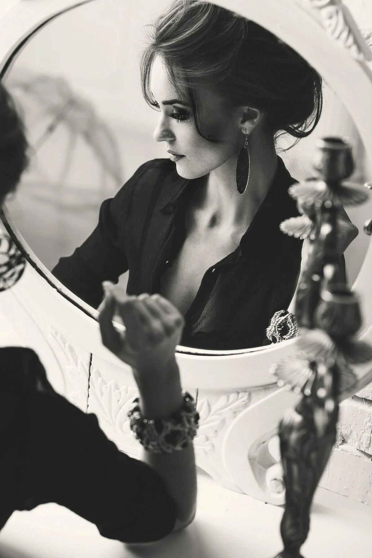 Woman_in_Black_Shirt_Reflecting_in_a_Mirror.jpg