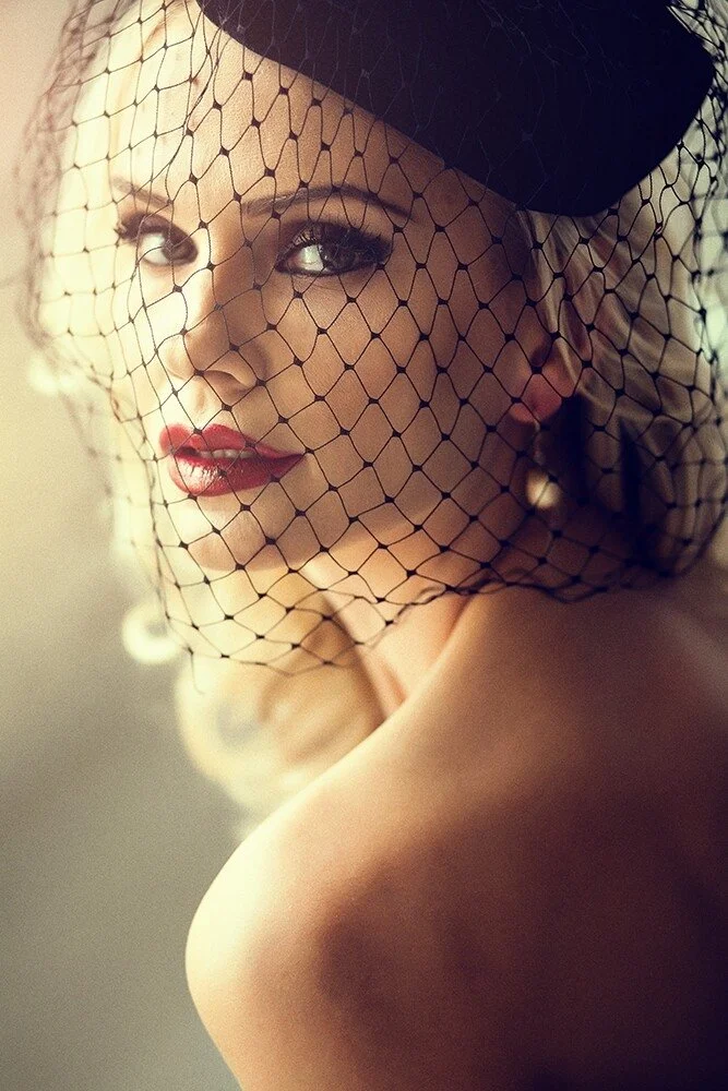 Woman_with_black_veil_and_red_lips_in_soft_light.jpg