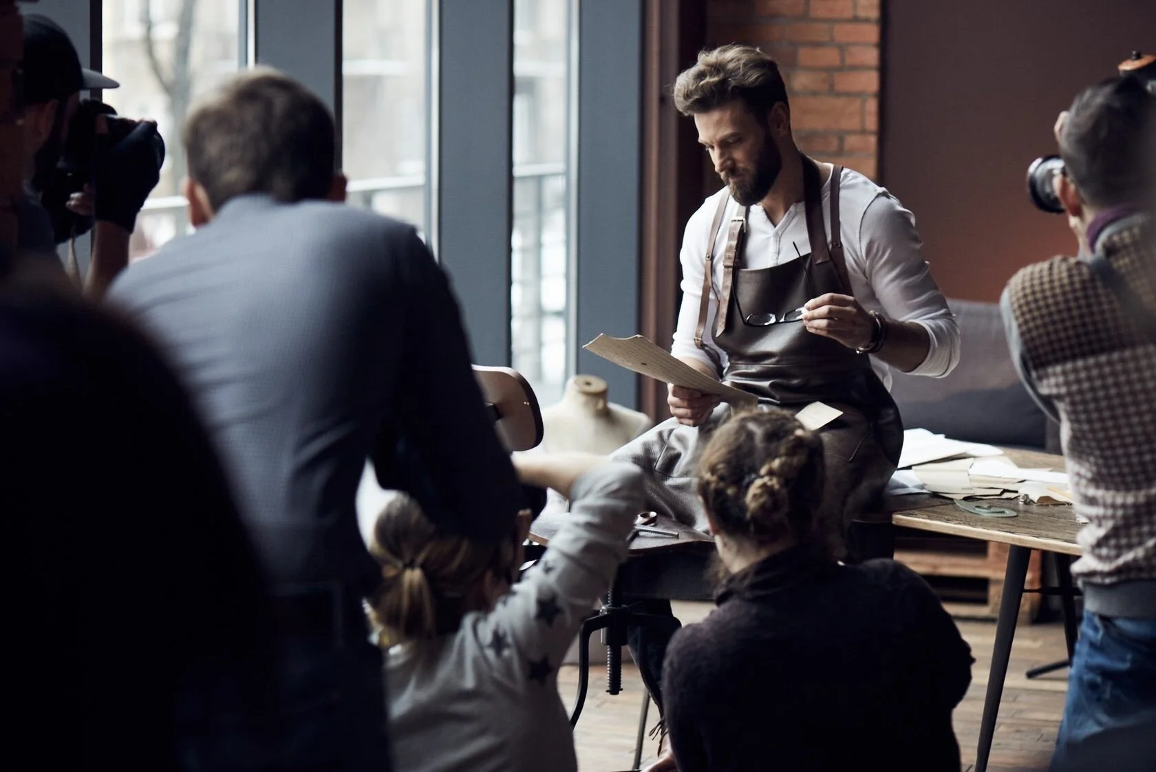 Craftsman_in_Workshop_with_Audience_Observing.jpg