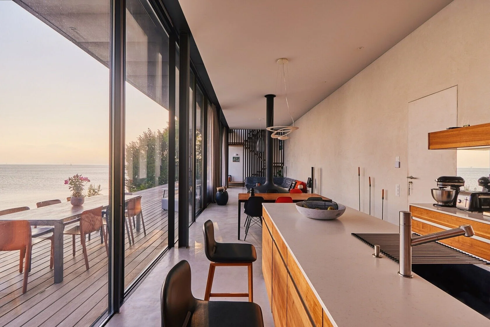 Modern_kitchen_with_wooden_accents_and_large_windows.jpeg