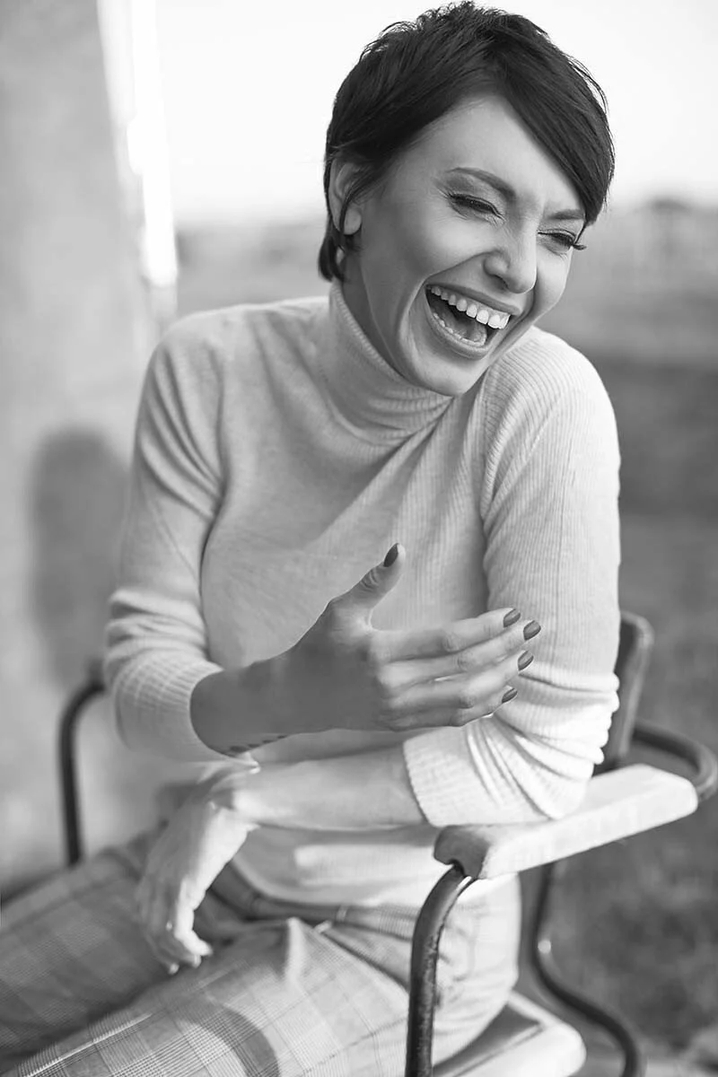 Woman_Laughing_in_Turtleneck_Sweater_and_Plaid_Pants.jpg