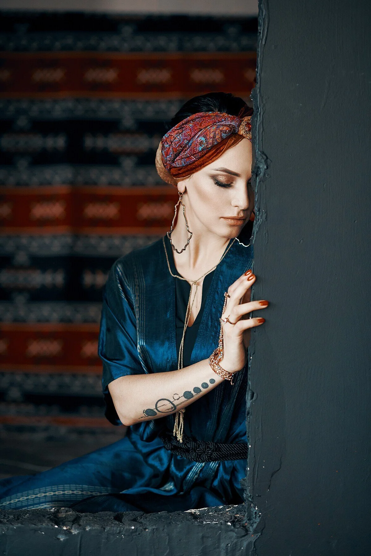 Woman_in_Blue_Attire_with_Colorful_Headscarf_and_Jewelry.jpg