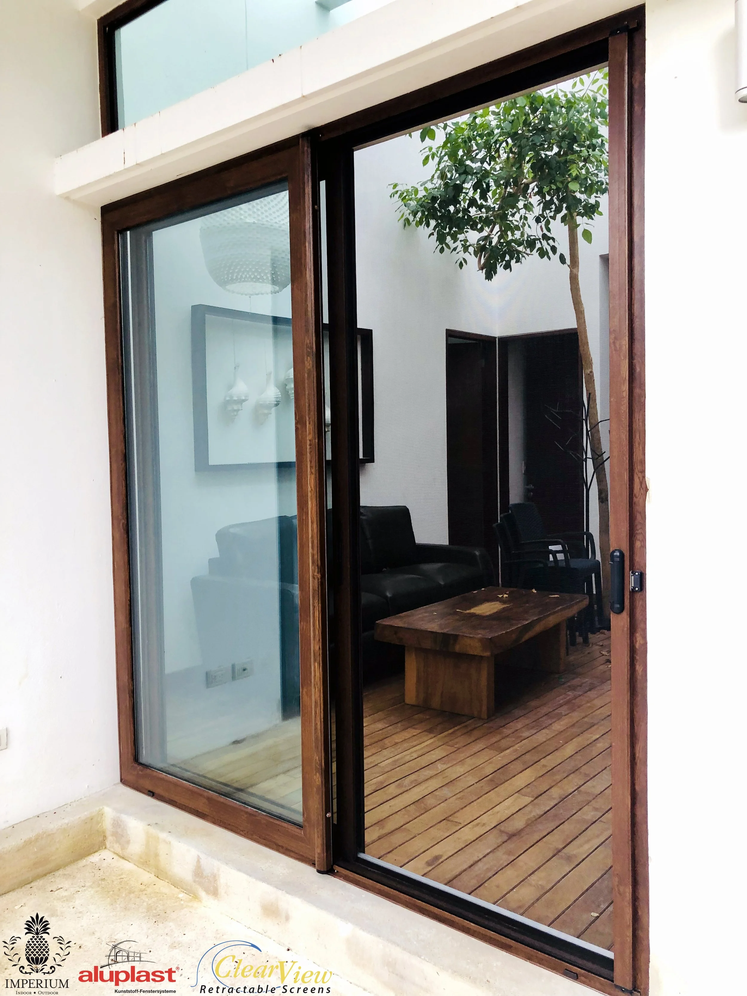 uPVC Sliding glass door with a wooden frame leading to a small patio.  Cancun, Puerto Morelos, Playa del Carmen, Puerto Aventuras, Akumal, Tulum.