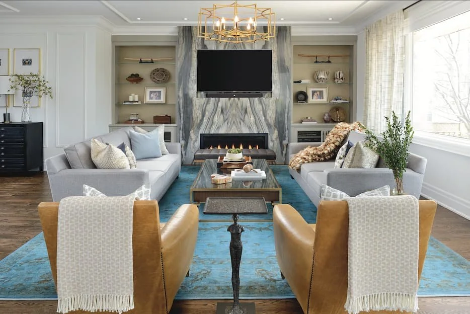 blue-floor-carpet-glass-table-and-marble-wall-decor-with-build-in-shelves-in-cozy-living-room.png