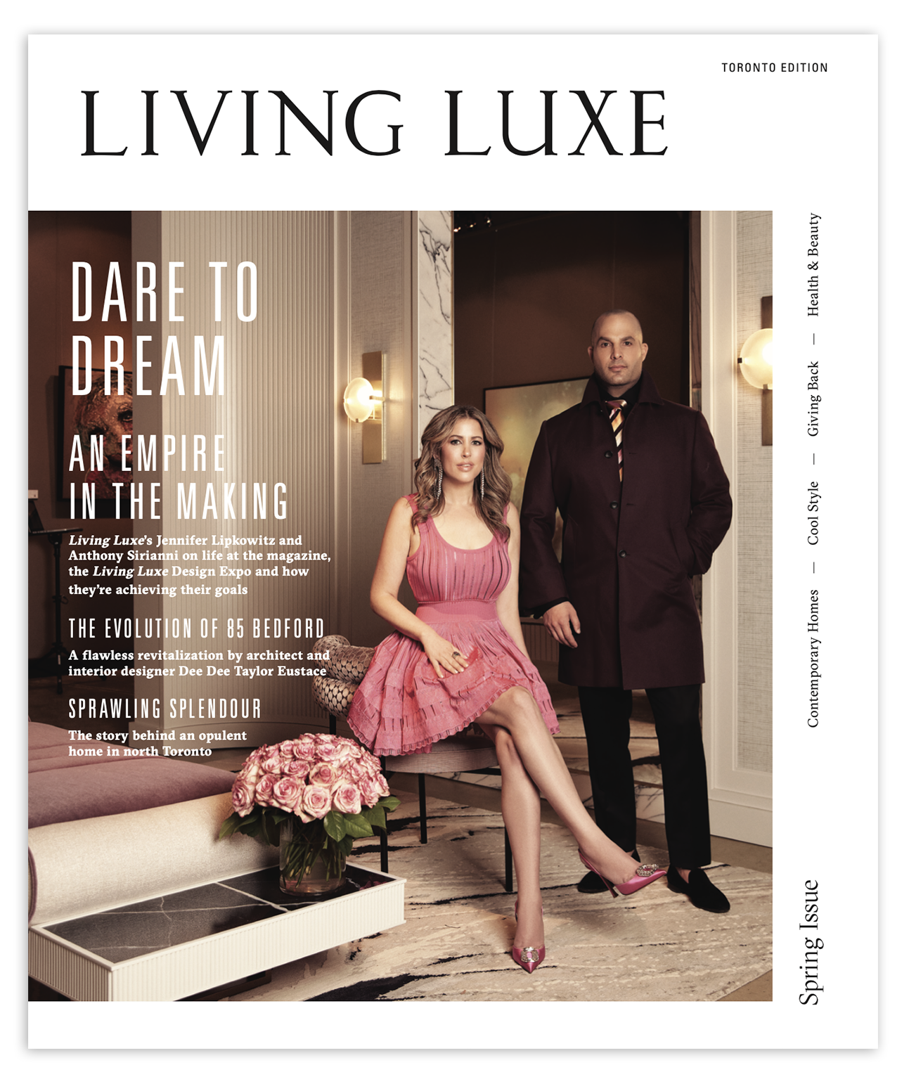 Cover of Living Luxe magazine featuring a woman in a pink dress and a man in a dark coat, standing in an elegant interior space with pink flowers on a table.