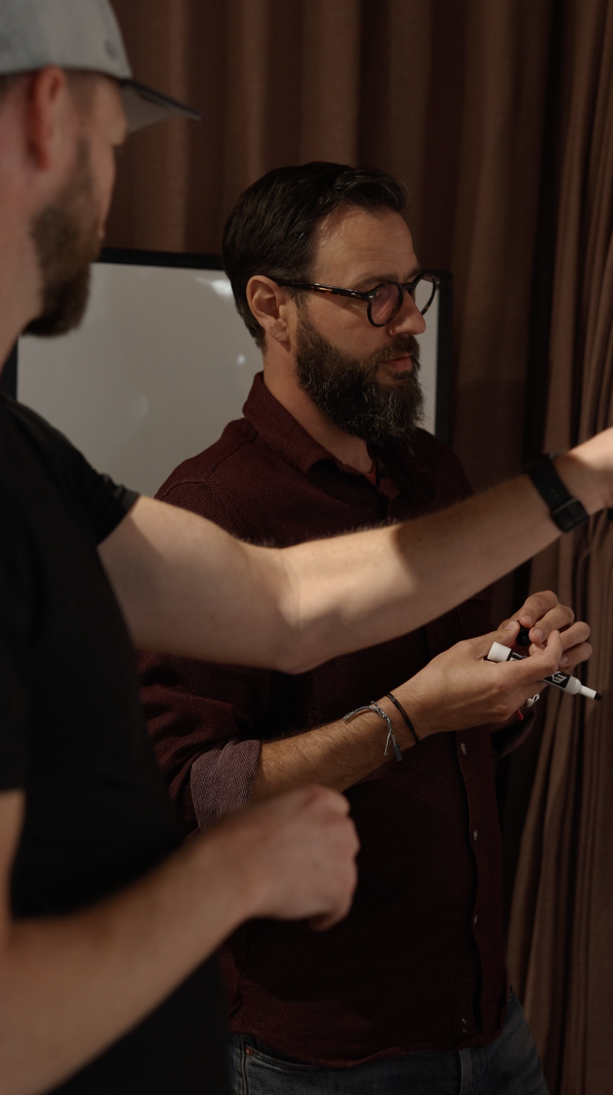Sam at a whiteboard, helping a small business owner get unstuck.