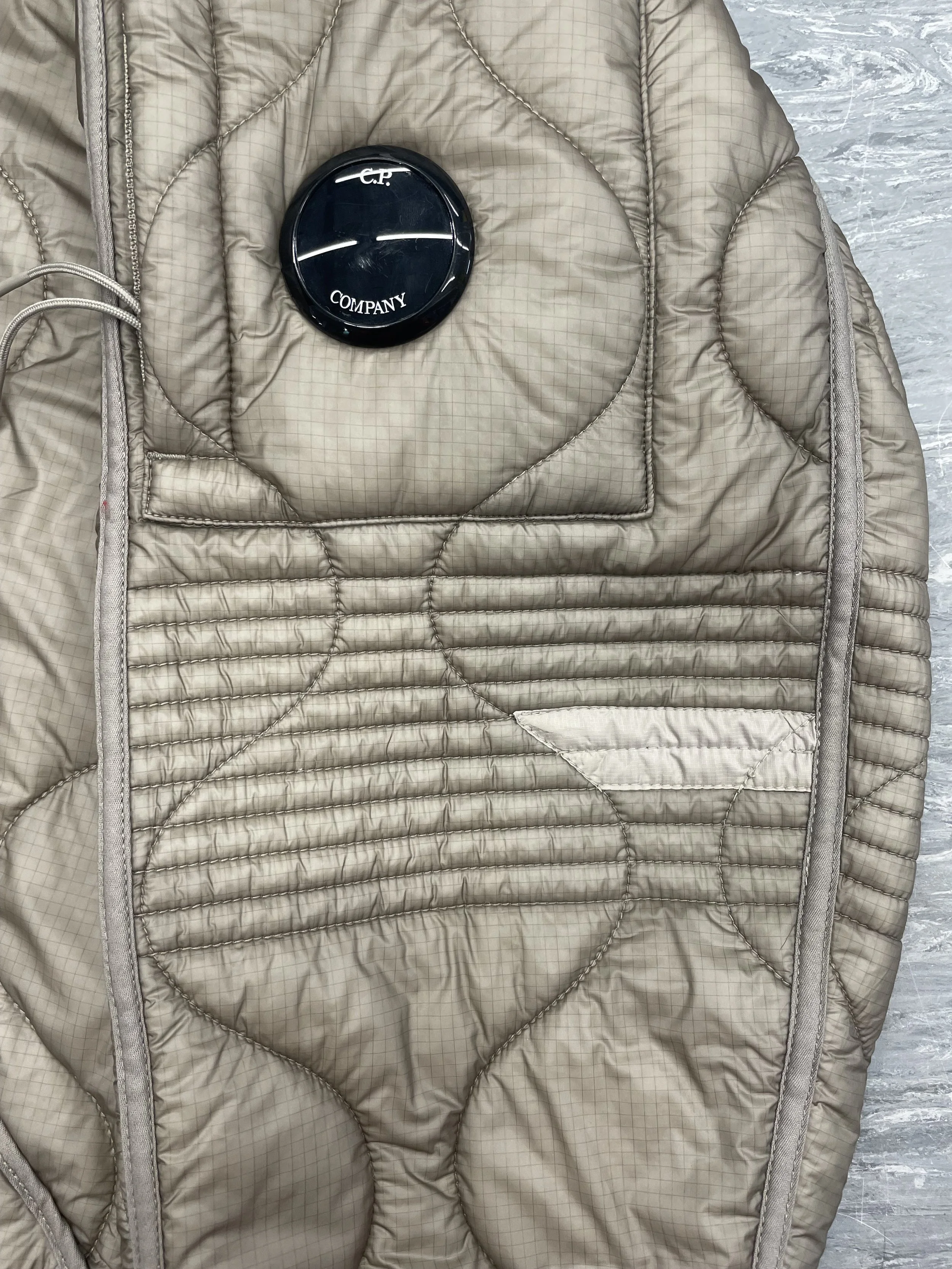 Discreet patch repair applied to seal damage and retain down filling