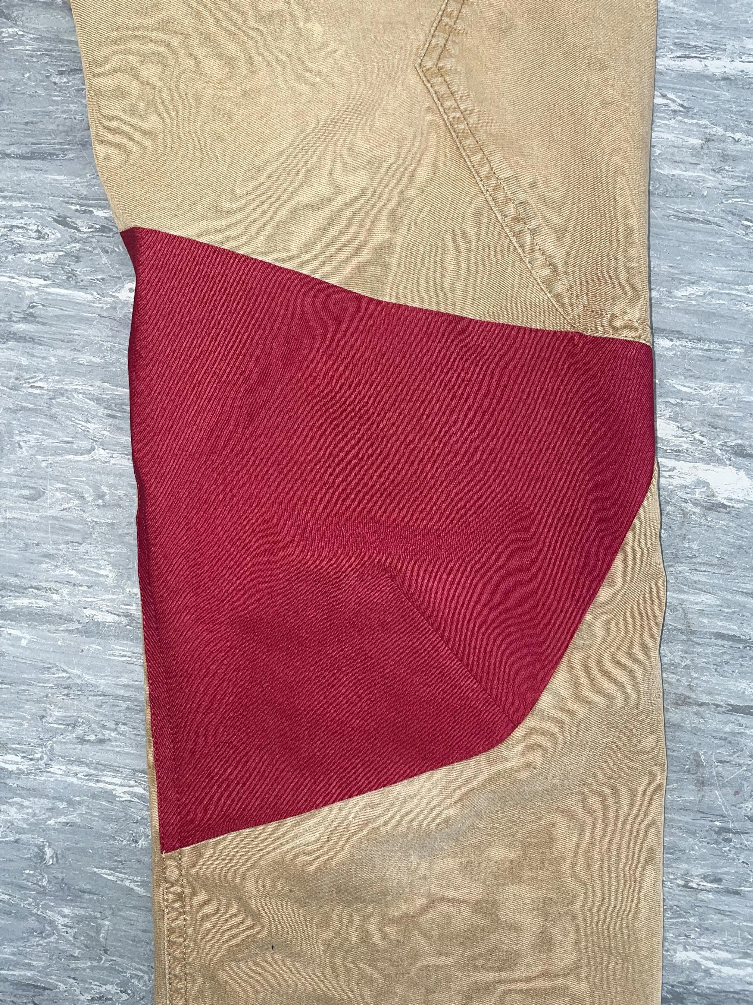 Red contrasting panel repair applied, with darting to maintain original shaping