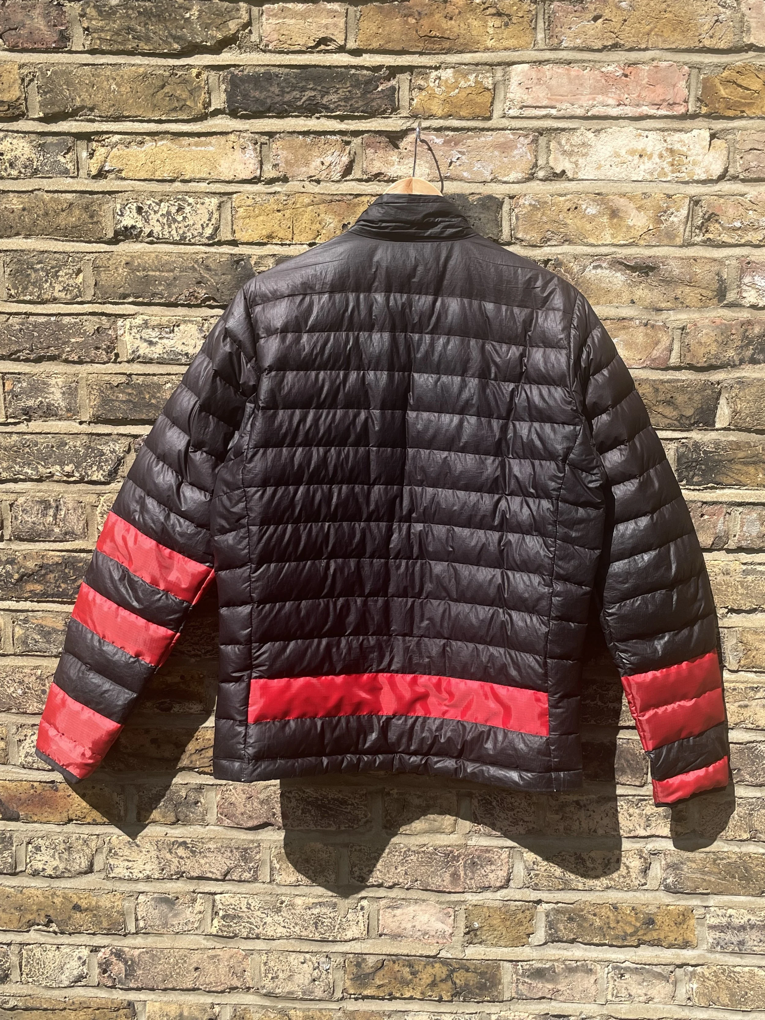 Reverse of Patagonia jacket with red patches across sleeves and back