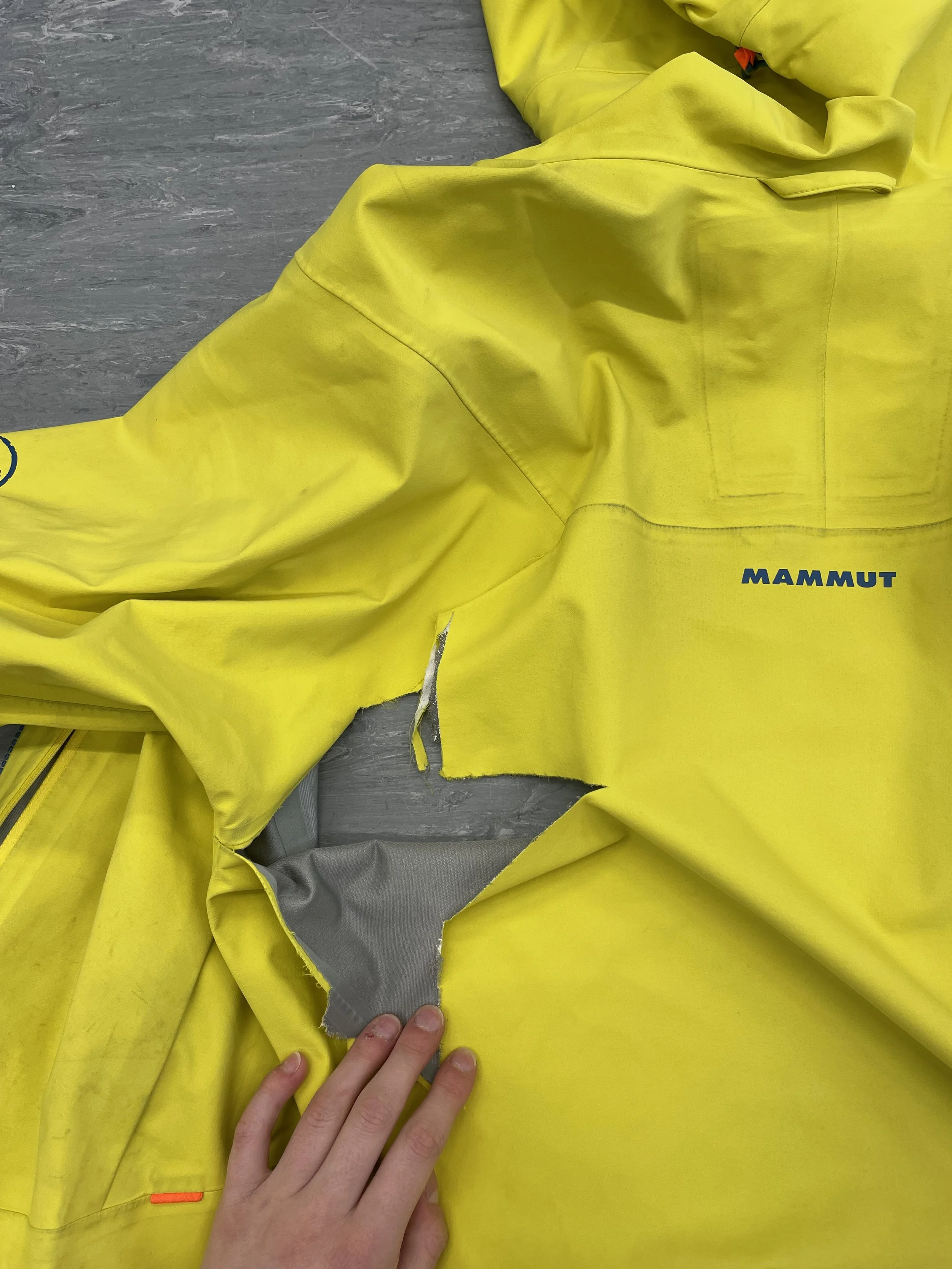 Severe tear to reverse of Mammut coat, affecting performance 