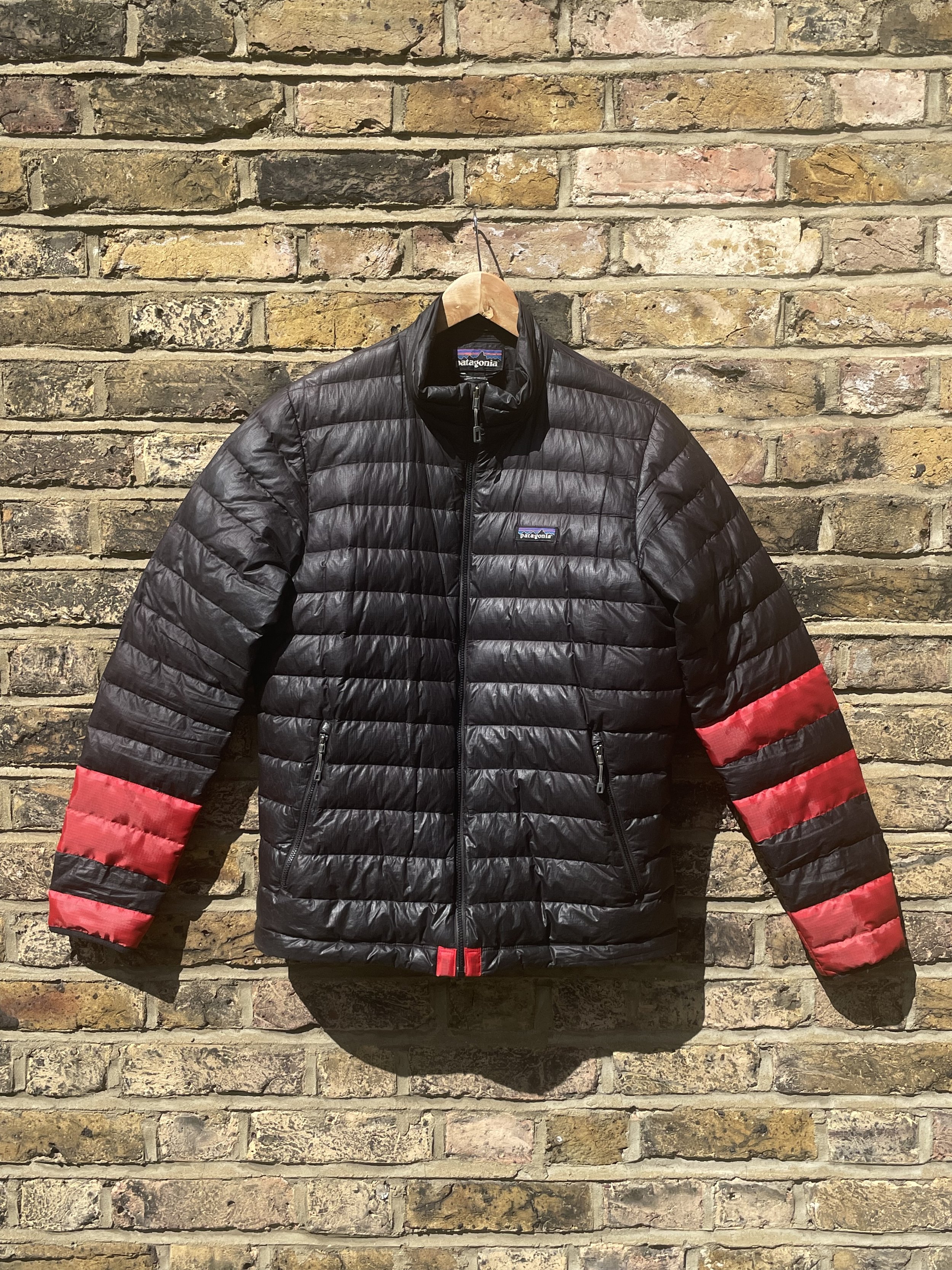 Creative coat repair with red patches covering multiple small holes